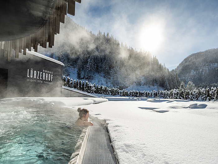 Eine Frau genießt die Zeit im Adults Only Pool im Wellnesshotel Lürzerhof in Salzburg